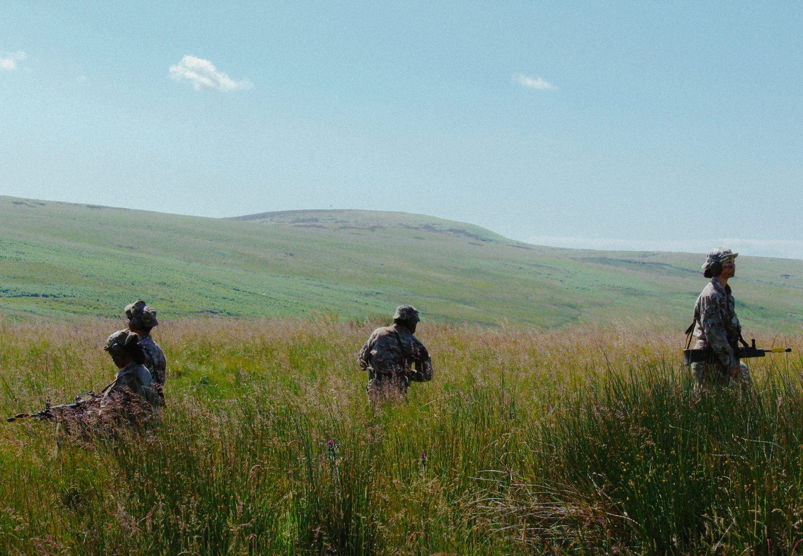 Cadets moving through long grass at Otterburn army camp