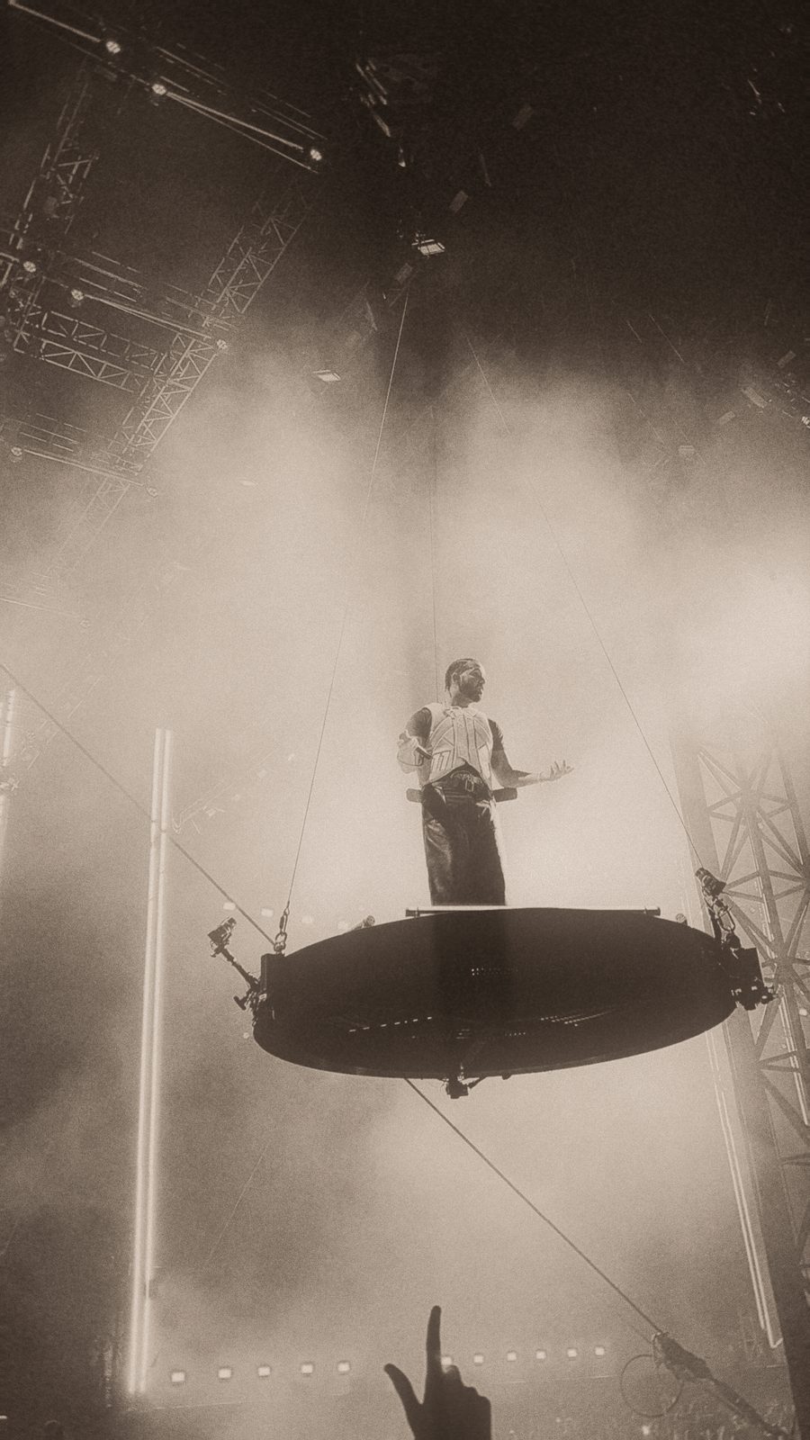 Drake on a raised platform above the crowd in sepia haze at Wireless